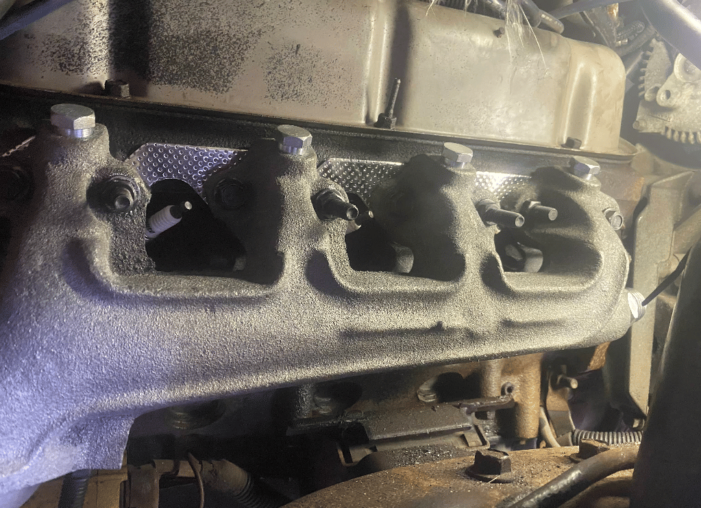 Refurbished engine manifold with fresh coating ready for reinstallation