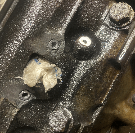 Close-up of engine block showing precision machining and leak repair work