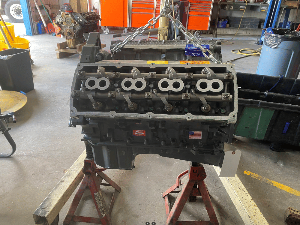 Remanufactured V8 engine head assembly on engine stand showing valve train components