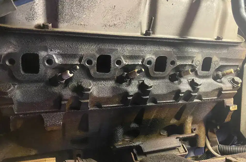 Engine cylinder head with intake manifold surface showing detailed machining work