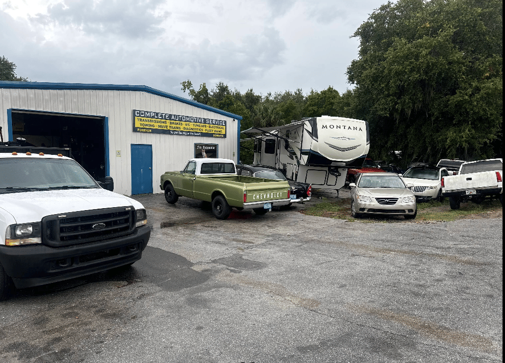 Exterior view of RJ Fox Automotive complete service facility with customer vehicles in parking lot